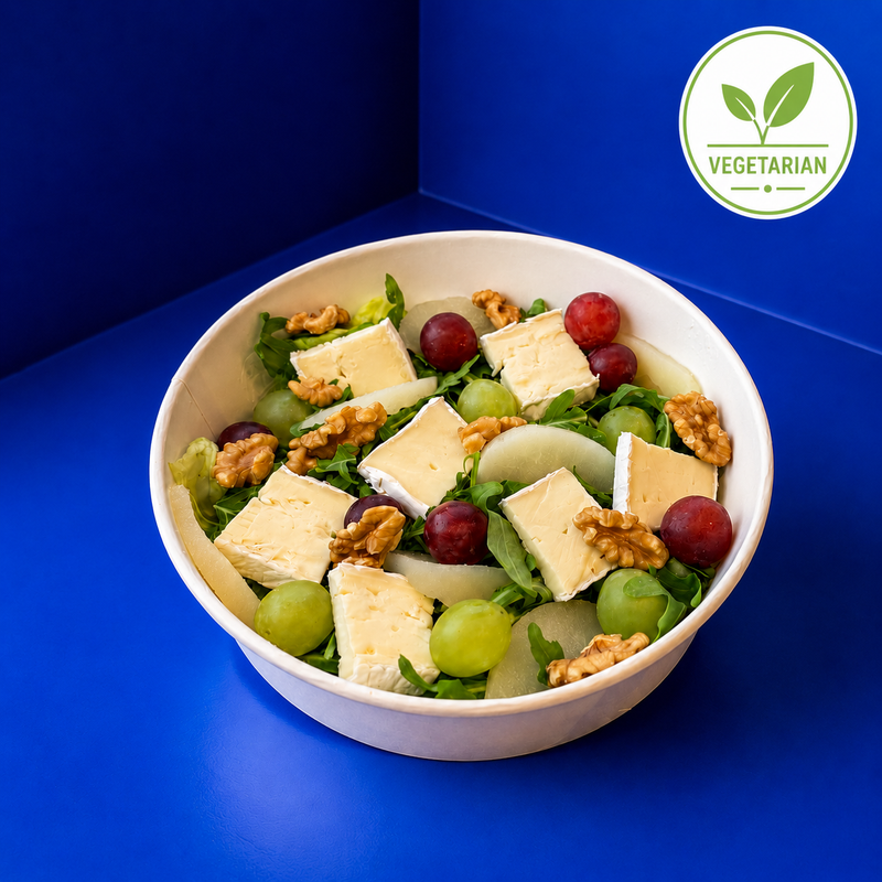 Vegetarian salad with lettuce, arugula, brie-cheese, fresh grapes, pears and walnuts